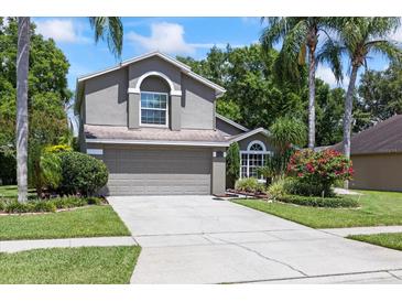Charming two-story home with a well-manicured lawn and a two car garage at 4047 Eagle Cove West Dr, Palm Harbor, FL 34685