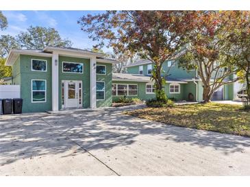 Stunning home featuring a unique color scheme and eye-catching architectural details at 5657 Oceanic Rd, Holiday, FL 34690