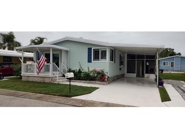 Charming single-story home with well-maintained lawn, carport, and covered porch at 123 S Dolphin Dr, Oldsmar, FL 34677