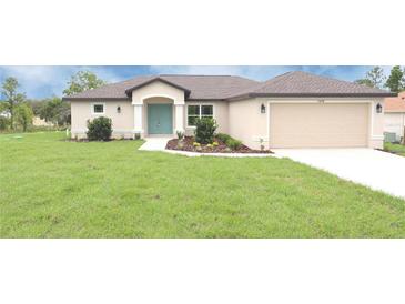 Charming single-story home with a well-manicured lawn and a welcoming light-blue front door at 13098 Convent Garden Rd, Brooksville, FL 34614