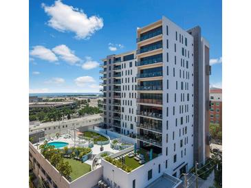 Modern condo building with balconies and rooftop pool and recreation area, perfect for city living at 199 Dali Blvd # 607, St Petersburg, FL 33701