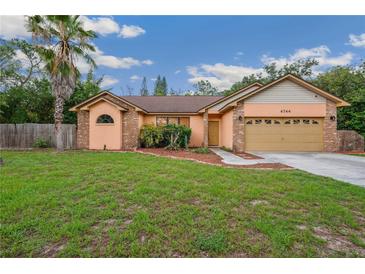 Charming single-story home boasts a well-manicured lawn and attached two-car garage at 4744 Burlington Rd, Land O Lakes, FL 34639