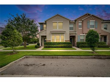 Charming two-story townhome featuring a well-manicured lawn and lush green hedges at 7325 Parkshore Dr, Apollo Beach, FL 33572