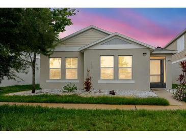Charming home featuring a well-maintained lawn, fresh landscaping, and inviting curb appeal at 13016 Boggy Creek Dr, Riverview, FL 33579