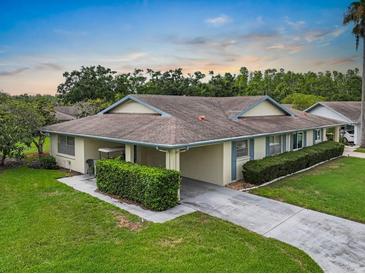 Charming single-story home featuring a well-maintained lawn, carport, and mature landscaping at 2006 Hadrian Ct, Sun City Center, FL 33573
