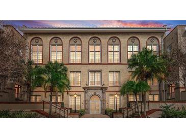 Beautiful historic building with many windows, palm trees, and elegant architectural details at 701 Mirror Lake N Dr # 103, St Petersburg, FL 33701