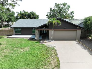 Charming single-story home with a well-manicured lawn and an attached two-car garage at 11525 Country Oaks Dr, Tampa, FL 33618