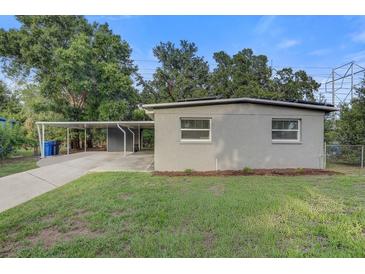 Charming single-story home with a cozy carport and well-maintained lawn at 2018 Windsor Way, Tampa, FL 33619