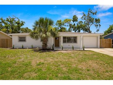 Charming single-story home with a well-manicured lawn, a palm tree, and a one car garage at 2066 62Nd Pl S 62Nd Pl, St Petersburg, FL 33712