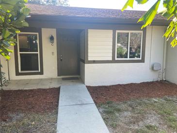 Inviting exterior view of a well-maintained single story home, featuring a walkway to the front door at 2160 Corbin Pl # C, Palm Harbor, FL 34683
