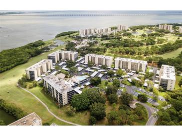 Stunning aerial view of the community with pool, parking, and views of the bay at 2900 Cove Cay Dr # 7C, Clearwater, FL 33760