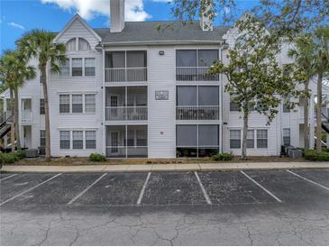 Three-story condo building with palm trees and ample parking at 3305 Haviland Ct # 101, Palm Harbor, FL 34684
