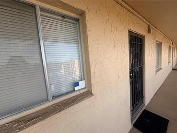 Exterior view of a condo with a window and security gate entrance at 4137 Lake Bayshore Dr # C505, Bradenton, FL 34205