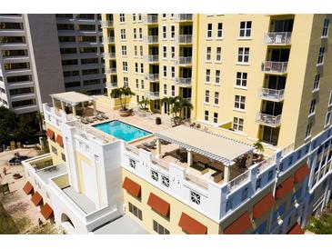 Stunning rooftop pool and lounge area with pergolas in a modern high-rise condo building at 628 Cleveland St # 711, Clearwater, FL 33755