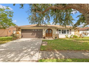Charming home featuring stone accents, a well-maintained lawn, and a double door entryway at 9309 120Th St, Seminole, FL 33772