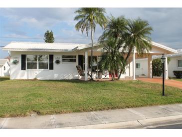 Charming single-story home with palm trees and a well-maintained front yard at 9705 45Th N Way, Pinellas Park, FL 33782