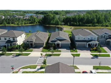 An aerial view shows the home's lakeside location and neighborhood at 17714 Everlong Dr, Land O Lakes, FL 34638
