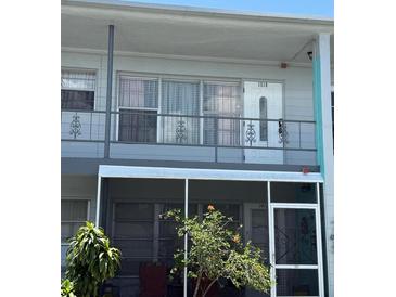 Two-story condo showcasing a screened-in lanai on the ground floor and a second-story balcony at 5860 43Rd N Ter # 1518, Kenneth City, FL 33709