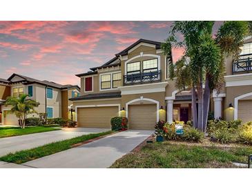 Beautiful two-story home featuring a two-car garage, well-kept lawn, and lush landscaping at sunset at 7849 52Nd E Ter, Bradenton, FL 34203