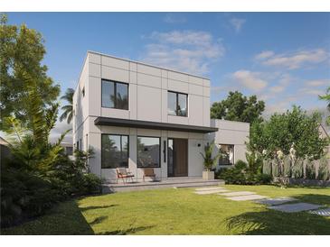 Modern two-story home featuring a sleek design, a well-manicured lawn and lush tropical landscaping at 805 Paris S Ave, St Petersburg, FL 33701