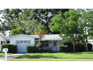 Charming single-story home with a well-maintained lawn and mature landscaping at 10871 86Th Ave, Seminole, FL 33772