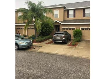 Charming townhome featuring a well-maintained yard, driveway, and single-car garage at 12820 Belvedere Song Way Way, Riverview, FL 33578