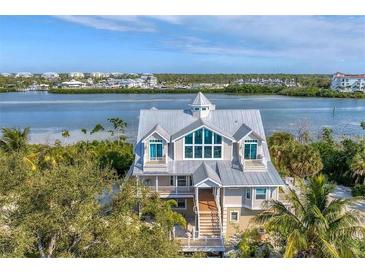 Stunning coastal home with a metal roof, multiple balconies, and scenic waterfront views at 3 Pointe Way, Placida, FL 33946