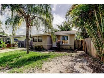 Charming single-story home with a tropical landscaped front yard and driveway at 4479 Newark N St, St Petersburg, FL 33714