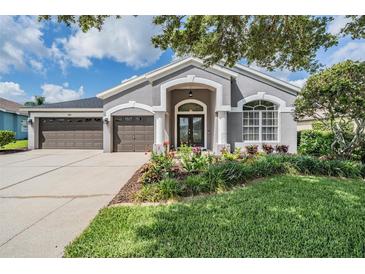 Charming one story home with a three car garage and beautiful landscaping at 5141 Riva Ridge Dr, Wesley Chapel, FL 33544