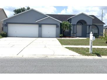 Charming one-story home with a well-manicured lawn, a two-car garage, and a welcoming front entrance at 11513 Andy Dr, Riverview, FL 33569
