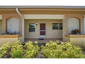 Inviting covered front entrance with decorative lattice and well-maintained landscaping, plus updated exterior paint at 2460 Northside Dr # 802, Clearwater, FL 33761