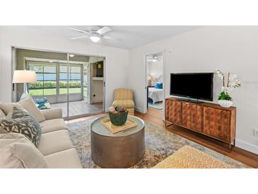 Comfortable living room with a sliding glass door to a patio and a glimpse of the bedroom at 2460 Northside Dr # 802, Clearwater, FL 33761