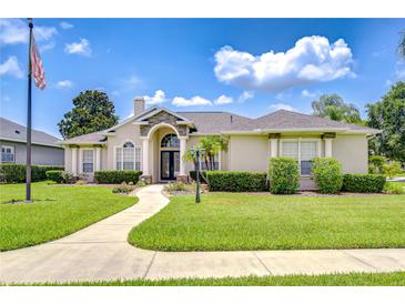 Well-manicured front yard with a lush green lawn and elegant landscaping creating a welcoming entrance at 1208 Carriage Park Dr, Valrico, FL 33594