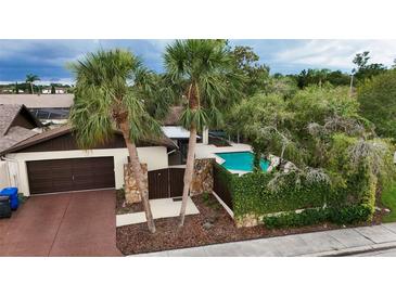 Charming home featuring a two-car garage, private pool, and beautiful mature trees at 13501 Avista Dr, Tampa, FL 33624