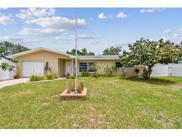 Charming single-story home featuring a well-maintained lawn and mature landscaping at 1707 Cardinal Dr, Clearwater, FL 33759