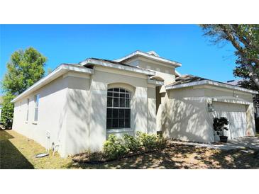 Charming single-Gathering home with a well-maintained stucco exterior and beautiful landscaping at 221 Fairmont Dr, Spring Hill, FL 34609
