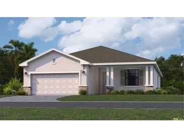 Charming single-story home featuring a two-car garage, neutral paint, stone accents, and a well-manicured lawn at 3515 Night Star Ter, Parrish, FL 34219