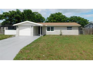 Charming single-story home with a well-maintained lawn and a freshly painted driveway at 4417 Kohler St, New Port Richey, FL 34652