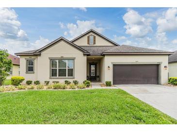 Charming one-story home with a well-manicured lawn and a two car garage at 4716 Butler National Dr, Wesley Chapel, FL 33543