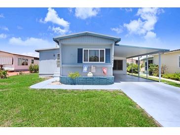 Charming single-story home with a covered carport and well-manicured lawn at 4904 Winged Foot Ave, Sarasota, FL 34234