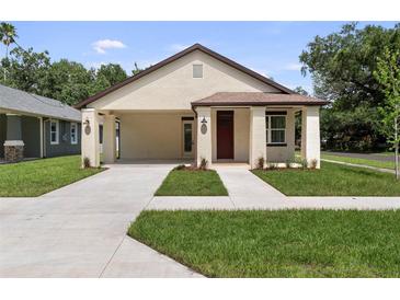Charming single-story home boasting a well-manicured lawn, covered entrance, and freshly painted exterior at 5701 N 20Th St, Tampa, FL 33610