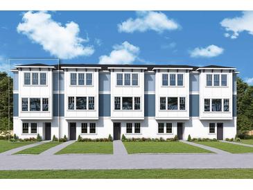 New townhome construction with a modern design, light blue accents, and well-maintained landscaping at 6605 N Nebraska Ave # 11, Tampa, FL 33604