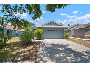Charming single Gathering home with a two-car garage and a well-maintained lawn in a suburban neighborhood at 7534 Oxford Garden Cir, Apollo Beach, FL 33572