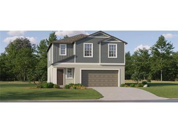 Charming two-story home with neutral siding, inviting entrance, and attached two car garage at 9437 Raised Tulip Ln, Land O Lakes, FL 34637