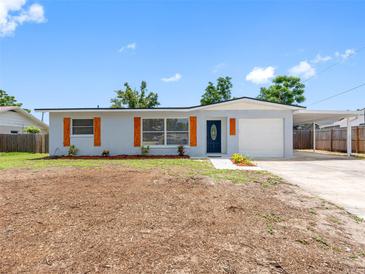 Charming single-story home featuring a carport, front lawn, and modern exterior paint at 1213 W Camellia Dr, Brandon, FL 33510