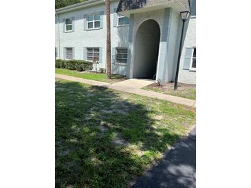 Two-story building with light blue exterior paint, blue shutters, and well-maintained landscaping in a sunny, inviting neighborhood at 337 S Mcmullen Booth Rd # 157, Clearwater, FL 33759