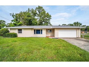 Charming single-story home with a well-maintained lawn and a classic suburban design at 410 N Corona Ave, Clearwater, FL 33765