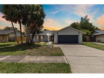 Charming single-Gathering home with a well-maintained lawn, complemented by mature trees and a two-car garage at 6509 W Longboat Blvd, Tampa, FL 33615