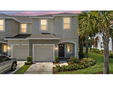 Charming two-story townhouse with a one-car garage and tropical landscaping at 7916 Evergreen Creek Ct, Riverview, FL 33578