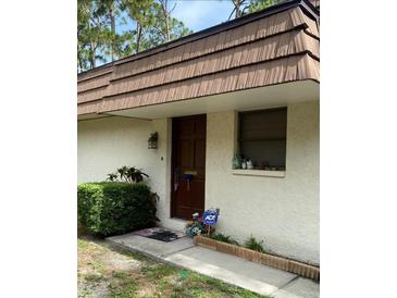 Charming front entrance with a well-kept garden and a secure ADT system at 8850 Dr Martin Luther King Jr N St # 8850, St Petersburg, FL 33702